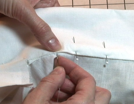 Sewing a whip stitch on a white shirt collar